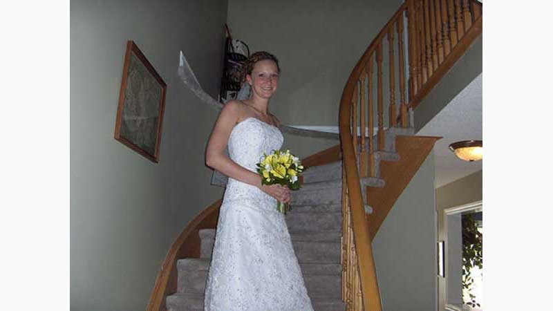 From wedding 3, DJ Niagara, Stunning blonde bride standing halfway on an oak spiral staircase. Taken in Niagara Ontario